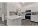Bright kitchen features white cabinets, stainless steel appliances, and stylish backsplash at 1633 E Lakeside Dr # 127, Gilbert, AZ 85234