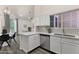 Open concept kitchen with stainless appliances and view into dining and living area at 1633 E Lakeside Dr # 127, Gilbert, AZ 85234