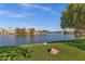 Picturesque lakeside view with lush green grass, mature shade trees, and lovely residences on the opposite shoreline at 1633 E Lakeside Dr # 127, Gilbert, AZ 85234