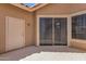 Private patio area with door and sliding glass door and beige exterior at 1633 E Lakeside Dr # 127, Gilbert, AZ 85234