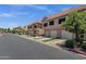 Street view of townhouses with tile roofs and green lawns at 1633 E Lakeside Dr # 127, Gilbert, AZ 85234