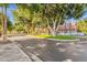 Neighborhood street scene with well-manicured lawns, mature trees, and view of the community sign at 1633 E Lakeside Dr # 127, Gilbert, AZ 85234