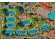 An aerial perspective of community tennis courts surrounded by greenery and neighborhood residences at 1633 E Lakeside Dr # 127, Gilbert, AZ 85234