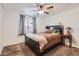 Warm bedroom with a ceiling fan, plush bedding, and a window, creating a comfortable retreat at 1718 W Voltaire Ave, Phoenix, AZ 85029