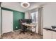 Bedroom converted into a home office features a gaming chair and multi-monitor setup at 1718 W Voltaire Ave, Phoenix, AZ 85029