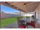 Covered patio featuring a dining table and chairs and views of the backyard at 1718 W Voltaire Ave, Phoenix, AZ 85029