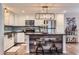 Well-lit kitchen boasts stainless appliances, white cabinetry, and a stylish island with counter seating at 1718 W Voltaire Ave, Phoenix, AZ 85029