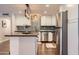 Modern kitchen with stainless steel appliances, sleek countertops, and a central island for food preparation at 1718 W Voltaire Ave, Phoenix, AZ 85029