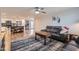 Open-concept living room and kitchen featuring wood-style floors and modern appliances at 1718 W Voltaire Ave, Phoenix, AZ 85029