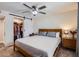Cozy bedroom with a ceiling fan, closet with sliding doors, and natural light from a window at 1718 W Voltaire Ave, Phoenix, AZ 85029