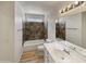 A bathroom with a toilet, vanity, and bath tub featuring modern fixtures and accents at 1739 E Carter Rd, Phoenix, AZ 85042