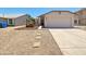Charming single-story home featuring a two-car garage, desert landscaping, and a quaint garden feature at 1739 E Carter Rd, Phoenix, AZ 85042