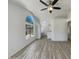 Open-concept living area with vaulted ceilings, a large window, and wood-look flooring at 1739 E Carter Rd, Phoenix, AZ 85042