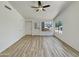 Spacious living room features wood-look flooring, white walls and ample natural light from multiple windows at 1739 E Carter Rd, Phoenix, AZ 85042