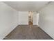 Empty main bedroom featuring neutral tones, updated carpet, and an en suite bathroom at 1739 E Carter Rd, Phoenix, AZ 85042