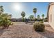 Large backyard featuring a trampoline, desert landscaping, and a putting green at 19576 N Portarosa Ct, Maricopa, AZ 85138