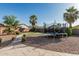 Beautiful backyard with a putting green, desert landscaping, and a walkway at 19576 N Portarosa Ct, Maricopa, AZ 85138