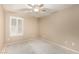 Bright bedroom with window shutters and ceiling fan awaiting your personal touch at 19576 N Portarosa Ct, Maricopa, AZ 85138