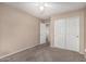 Bedroom featuring neutral walls, a modern ceiling fan and access to a closet at 19576 N Portarosa Ct, Maricopa, AZ 85138