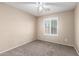 Bedroom featuring neutral walls, a modern ceiling fan and plantation shutters at 19576 N Portarosa Ct, Maricopa, AZ 85138
