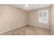 This bedroom features tile floor and lots of natural light from the shuttered window at 19576 N Portarosa Ct, Maricopa, AZ 85138