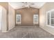 Spacious bedroom featuring neutral walls, vaulted ceilings and modern ceiling fan at 19576 N Portarosa Ct, Maricopa, AZ 85138