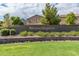Elegant community sign reading 'Glennwildegroves' set against a backdrop of mature landscaping at 19576 N Portarosa Ct, Maricopa, AZ 85138