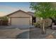 Charming single-story home with a two-car garage, desert landscaping, and a tile roof at 19576 N Portarosa Ct, Maricopa, AZ 85138