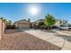 Inviting single-story home with a well-maintained yard, a spacious driveway, and desert rock landscaping at 19576 N Portarosa Ct, Maricopa, AZ 85138