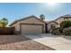 Charming single-story home featuring a desert landscape, two-car garage, and inviting front entrance at 19576 N Portarosa Ct, Maricopa, AZ 85138