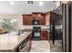 Well-equipped kitchen boasting stainless steel appliances, a double sink, and generous countertop space at 19576 N Portarosa Ct, Maricopa, AZ 85138