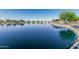 Serene pond with clear water and scenic surroundings, enhancing the community's natural beauty at 19576 N Portarosa Ct, Maricopa, AZ 85138