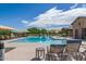 Resort-style pool with lounge chairs and shade, offering a relaxing and luxurious experience for residents at 19576 N Portarosa Ct, Maricopa, AZ 85138