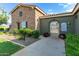 Entrance gate to the community pool area surrounded by lush greenery and stone accents at 19576 N Portarosa Ct, Maricopa, AZ 85138