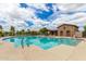 Gorgeous community pool with lounge area and building, perfect for relaxing on a warm day at 19576 N Portarosa Ct, Maricopa, AZ 85138