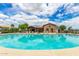 Beautiful community pool with a lounge area, plenty of seating, and clear blue water at 19576 N Portarosa Ct, Maricopa, AZ 85138
