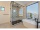 Luxurious bathroom features a glass shower, freestanding tub, and modern fixtures at 2005 W Lincoln Ct, Queen Creek, AZ 85144