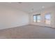 Spacious bedroom features a large window and neutral carpet at 2005 W Lincoln Ct, Queen Creek, AZ 85144