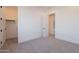 Bright bedroom with neutral carpet and doors to a walk-in closet and a secondary closet at 2005 W Lincoln Ct, Queen Creek, AZ 85144