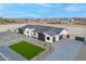 An aerial view captures the home's gray roof, modern exterior, driveway, landscaping, and neighborhood at 2005 W Lincoln Ct, Queen Creek, AZ 85144