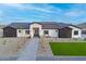 Inviting front exterior featuring contemporary design, lush turf, and a paved walkway leading to the entrance at 2005 W Lincoln Ct, Queen Creek, AZ 85144