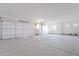 Spacious three-car garage with white doors and a concrete floor at 2005 W Lincoln Ct, Queen Creek, AZ 85144