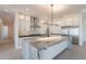A large kitchen features an island with granite counters, stainless steel appliances, and shaker-style cabinets at 2005 W Lincoln Ct, Queen Creek, AZ 85144