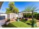 Lush backyard featuring artificial grass, a storage shed, and a shaded pergola area at 201 S Greenfield Rd # 29, Mesa, AZ 85206