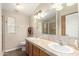 Well-lit bathroom featuring a double-sink vanity with ample counter space and storage at 201 S Greenfield Rd # 29, Mesa, AZ 85206