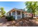 Charming single-story home with a welcoming front porch and well-maintained landscaping at 201 S Greenfield Rd # 29, Mesa, AZ 85206