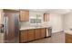 Updated kitchen with stainless steel appliances, wood cabinetry, and tile backsplash at 201 S Greenfield Rd # 29, Mesa, AZ 85206