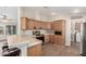 Efficient kitchen with wooden cabinets, stainless steel appliances, and a breakfast bar at 201 S Greenfield Rd # 29, Mesa, AZ 85206