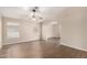Inviting living room featuring hardwood floors, large windows, and an arched doorway at 201 S Greenfield Rd # 29, Mesa, AZ 85206