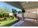 Well decorated patio with faux lawn, water feature, overhead fan and privacy screen at 201 S Greenfield Rd # 29, Mesa, AZ 85206